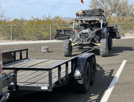 UTV secured on flatbed trailer